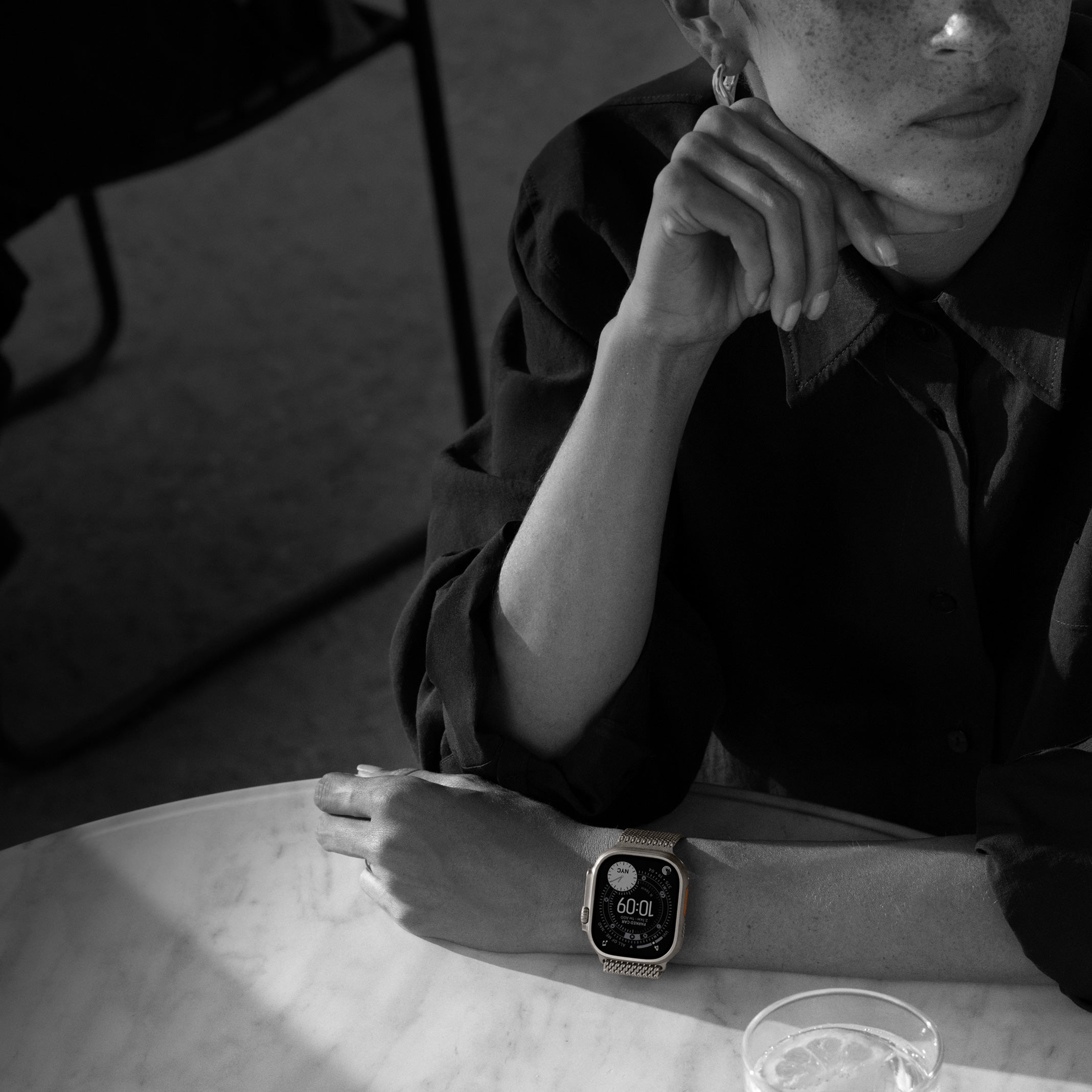 Titanium Apple Watch bands including the Milanese Loop and Link Bracelet displayed in a premium metal finish.